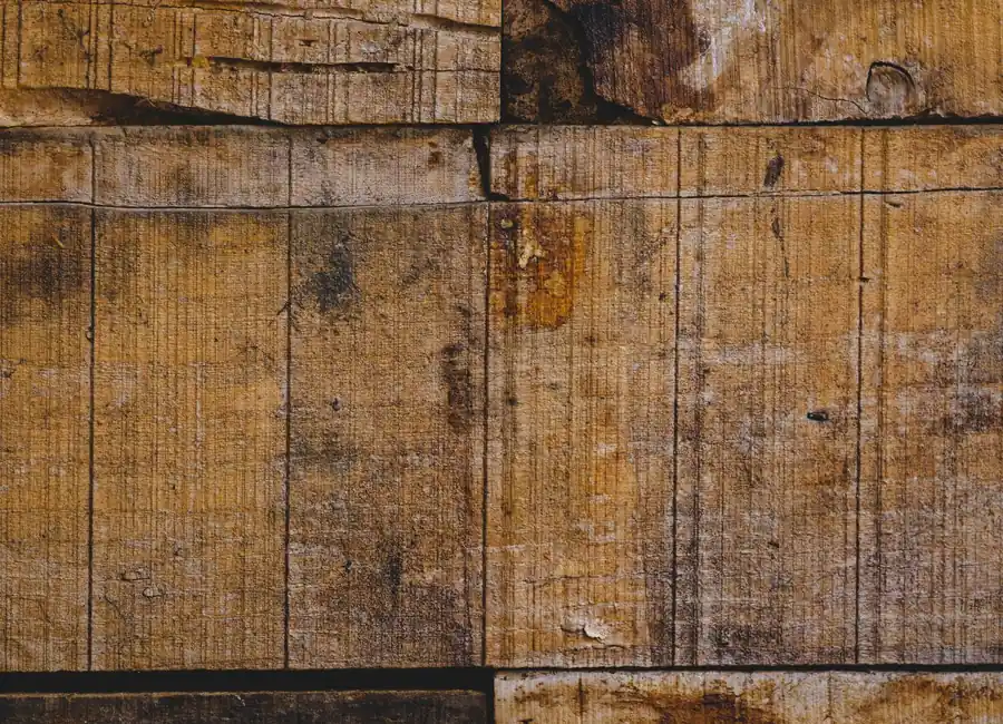 Closeup of old, weathered wooden planks showcasing a rustic and vintage texture.