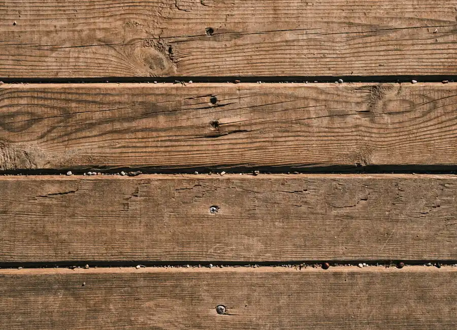 Close-up of natural wooden planks showcasing unique grain and texture, perfect as a background.
