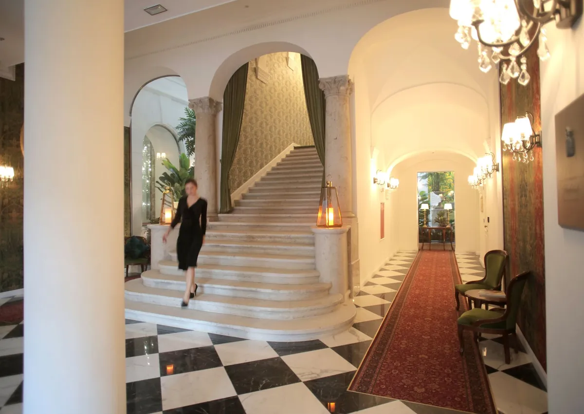 Luxurious hotel lobby featuring a grand staircase and elegant interior design